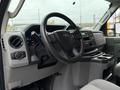 Interior view of a 2022 Ford E-450 showcasing the steering wheel dashboard controls and console