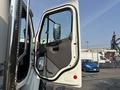 A 2010 Freightliner M2 106 truck with an open driver side door showcasing the interior handle and mirror