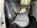 Interior view of a 2015 Ford F-550 featuring a row of gray fabric seats with seatbelts visible