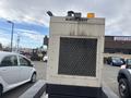 A 2005 Katolight SED60FPJ4 generator with a metal grid front and top warning lights