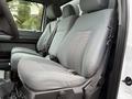 The interior of a 2012 Ford F-550 with gray cloth seats featuring a patterned design and seatbelts visible on the front passenger seats