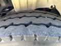 Close-up of a textured tire tread from a 2005 Freightliner M2 106 exhibiting grooves and patterns designed for traction