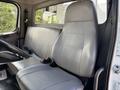 Interior of a 2019 Freightliner M2 106 featuring a gray vinyl driver's seat and a bench seat with seatbelts