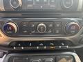Interior controls of a 2017 Chevrolet Silverado 1500 featuring climate control dials and multimedia buttons