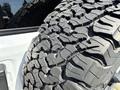 A close-up of a rugged tire from a 2021 Jeep Wrangler showcasing deep treads designed for off-road traction