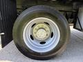 Close-up of a silver wheel on a 2019 Ford F-550 with a black tire showcasing detailed treads and a multi-spoke hub design