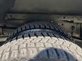 Close-up view of a tire from a 2012 Ford Econoline showcasing the tread pattern and rubber surface