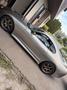 A silver 1997 Toyota Supra parked at an angle showing its sleek design and sporty wheels
