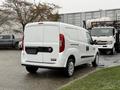 A white 2017 RAM ProMaster City van is parked with its rear view visible showcasing its doors and rear lights
