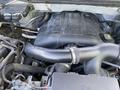 Engine compartment of a 2014 Ford F-150 showing the V6 engine with various hoses and components visible