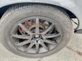 A close-up of a black alloy wheel from a 1968 Ford Mustang Two Door Convertible showcasing multiple spokes and a visible brake disc