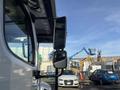 A 2022 Freightliner M2 106 truck with a prominent side mirror reflecting the surroundings