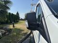 A white 2019 Ford Transit 350 van with a side mirror visible in the foreground