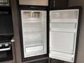 An open refrigerator with shelves and drawers inside a 2021 Jayco Jay Flight travel trailer