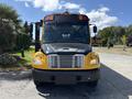 Front view of a yellow 2011 Freightliner B2 bus with multiple headlights and a black hood