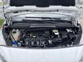 The engine compartment of a 2019 Ford Transit Connect with various engine components and hoses visible