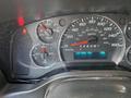 Instrument panel of a 2023 GMC Savana showing speedometer tachometer and gauges for temperature and pressure