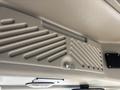 Interior view of a Chevrolet Express showing a textured overhead panel with ventilation slits and a small keyhole