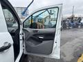 A 2019 Ford Transit Connect with an open driver's side door showcasing the interior door panel and handle