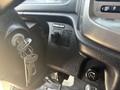 Close-up of the dashboard of a 2012 Hino 338 showing the ignition key, dome light switch, and a knob for vehicle controls