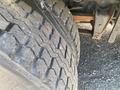 Close-up of a tire on a 1997 Freightliner FL70 showing detailed tread patterns and wear on the rubber surface