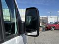 A side mirror of a 2016 Mercedes-Benz Sprinter showing a reflective surface and a black casing