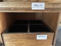 A wooden box with compartments labeled REG'S and METERS inside a larger wooden frame