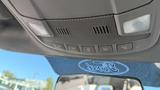 A 2016 Ford F-150 interior view showing overhead controls and lights above the rearview mirror