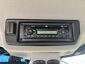 A black control panel with various buttons and a digital display showing the time 1:47 PM and Bluetooth functionality for a 2012 Caterpillar 980