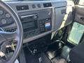 Interior dashboard of a 2020 Peterbilt 330 featuring gauges a radio control panel and cup holders
