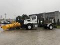 A 2016 Freightliner 108SD truck equipped with a large yellow snow plow attachment mounted at the front