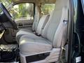 Interior view of a 2008 Ford F-550 showing two light gray front seats and a steering wheel in the foreground