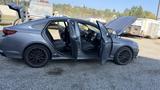 A 2018 Hyundai Sonata with doors wide open and the hood raised showcasing a gray exterior and black rims