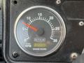 A close-up of a dashboard gauge displaying RPM and engine hours with a needle indicating just above zero on the RPM scale and a digital readout showing engine hours