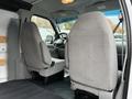 Interior view of a 2006 Ford Econoline van showing two gray fabric front seats and the cabin area