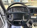 The interior of a 2019 Freightliner M2 106 showing the steering wheel dashboard gauges and control buttons