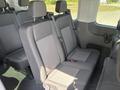 2025 Ford Transit T-350 interior with multiple seats arranged in rows featuring gray upholstery and headrests