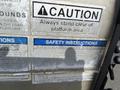 A 2014 Ford F-250 SD with a silver exterior parked with safety instructions and caution signs visible on the tailgate