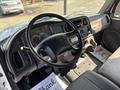 Interior view of a 2019 Freightliner M2 106 featuring a black steering wheel dashboard controls and seats with floor mats stating thank you