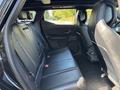 Interior view of the backseat of a 2023 Fisker Ocean with black leather seats and a modern design
