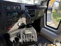 Interior view of a 2017 Chevrolet Express showing the dashboard controls and gear shift area with various buttons and knobs