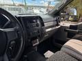 Interior view of a 2017 Ford F-550 showing the dashboard controls and seating with a patterned fabric cover