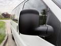 A close-up view of the side mirror of a 2004 Chevrolet Express van