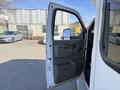 A 2017 Chevrolet Express van with its driver's side door open showing the interior handle and storage compartments