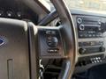 Close-up of the steering wheel of a 2014 Ford F-550 featuring controls for media volume seek and options