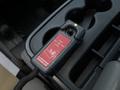 A control device for a snow plow featuring a red panel with a graphic illustration and indicator light