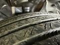 A close-up view of a worn tire tread of a 2014 Honda Odyssey with visible grooves and debris embedded in the rubber surface