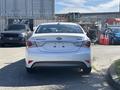 A 2015 Hyundai Sonata Hybrid seen from the rear with a white exterior and distinctive taillights