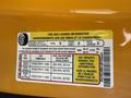 A tire and loading information sticker on a 2014 Ford F-150 detailing seating capacity and tire pressure requirements