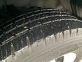 Close-up of a wet tire tread on a 2015 Chevrolet Express showing deep grooves and textured surface designed for traction